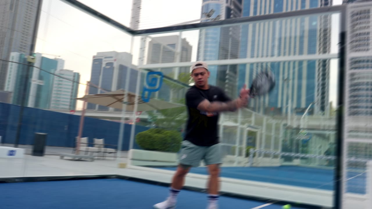 A serve, with the skyline behind